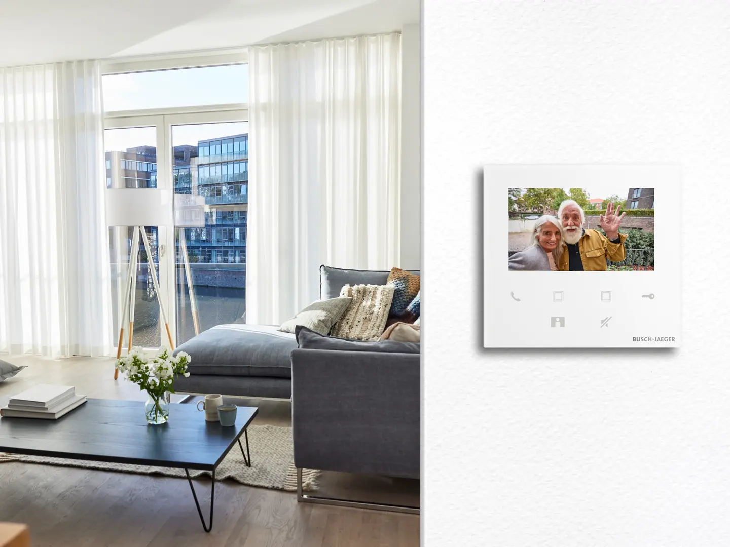 Ein moderner Lichtschalter mit einem Foto von zwei Personen, dargestellt an einer hellen Wand in einem Wohnzimmer.